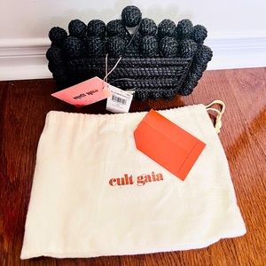Medium size black clutch with unique design and details with tags on